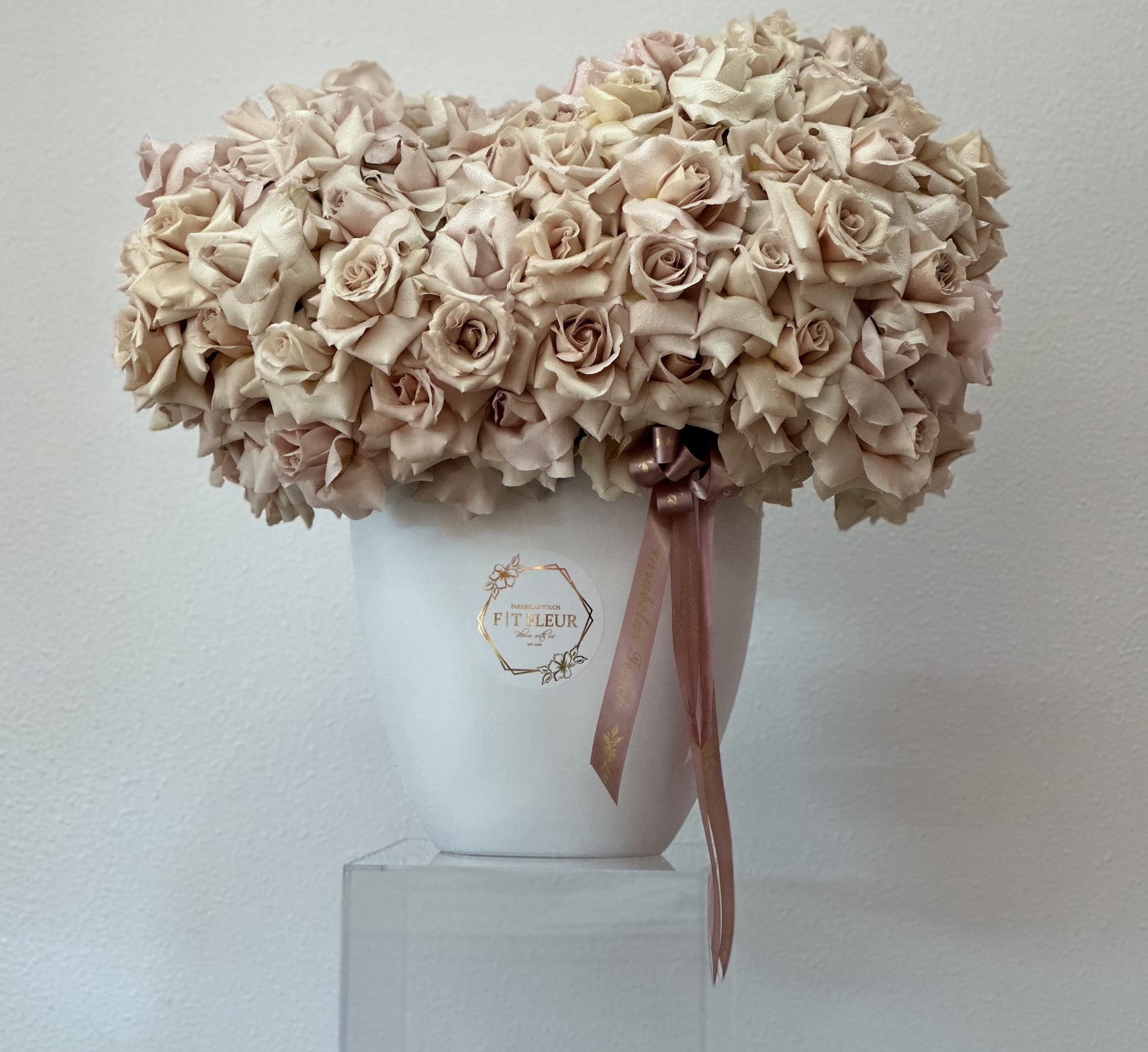 Moonbin  - Bring beauty to the table with elegant arrangement, presented in a tall vase. This arrangement features roses all around   Due to the seasonality of flowers or supply chain issues, substitutions may occasionally need to be made. While we understand this is an inconvenience, we will fill your order with an arrangement of similar color and design style.