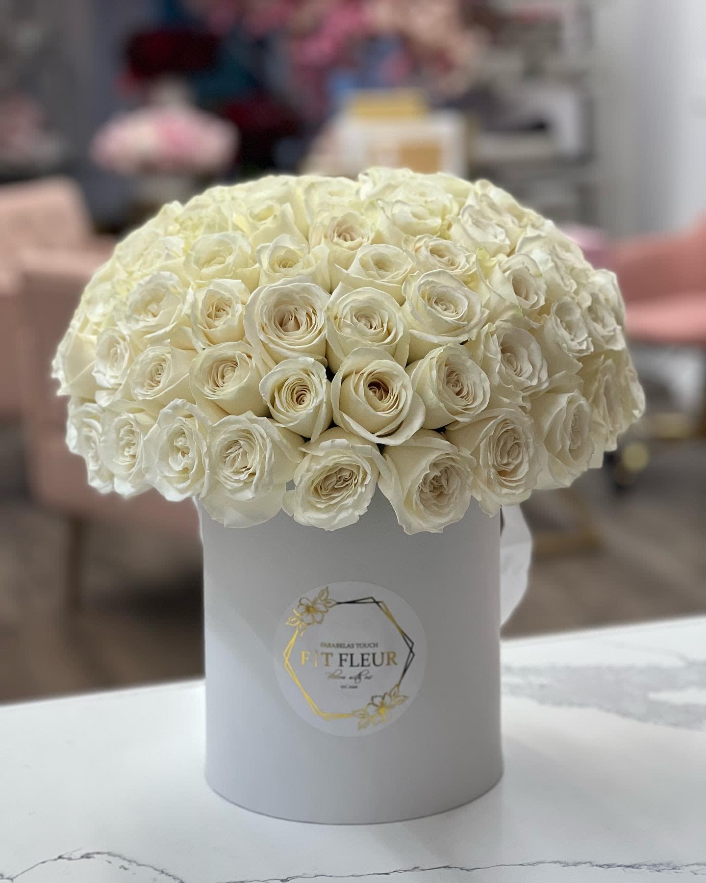 Elegant white - Bring beauty to the table with elegant arrangement, presented in a hat box. This arrangement features roses.   Due to the seasonality of flowers or supply chain issues, substitutions may occasionally need to be made. While we understand this is an inconvenience, we will fill your order with an arrangement of similar color and design style.