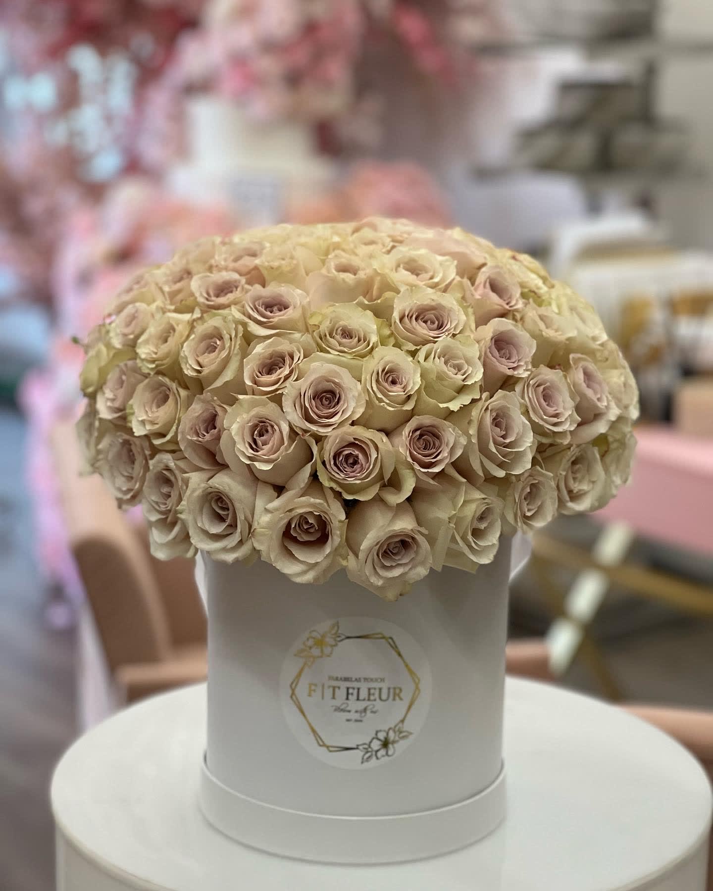 Sandie  - Bring beauty to the table with elegant arrangement, presented in a hat box. This arrangement features roses.   Due to the seasonality of flowers or supply chain issues, substitutions may occasionally need to be made. While we understand this is an inconvenience, we will fill your order with an arrangement of similar color and design style.