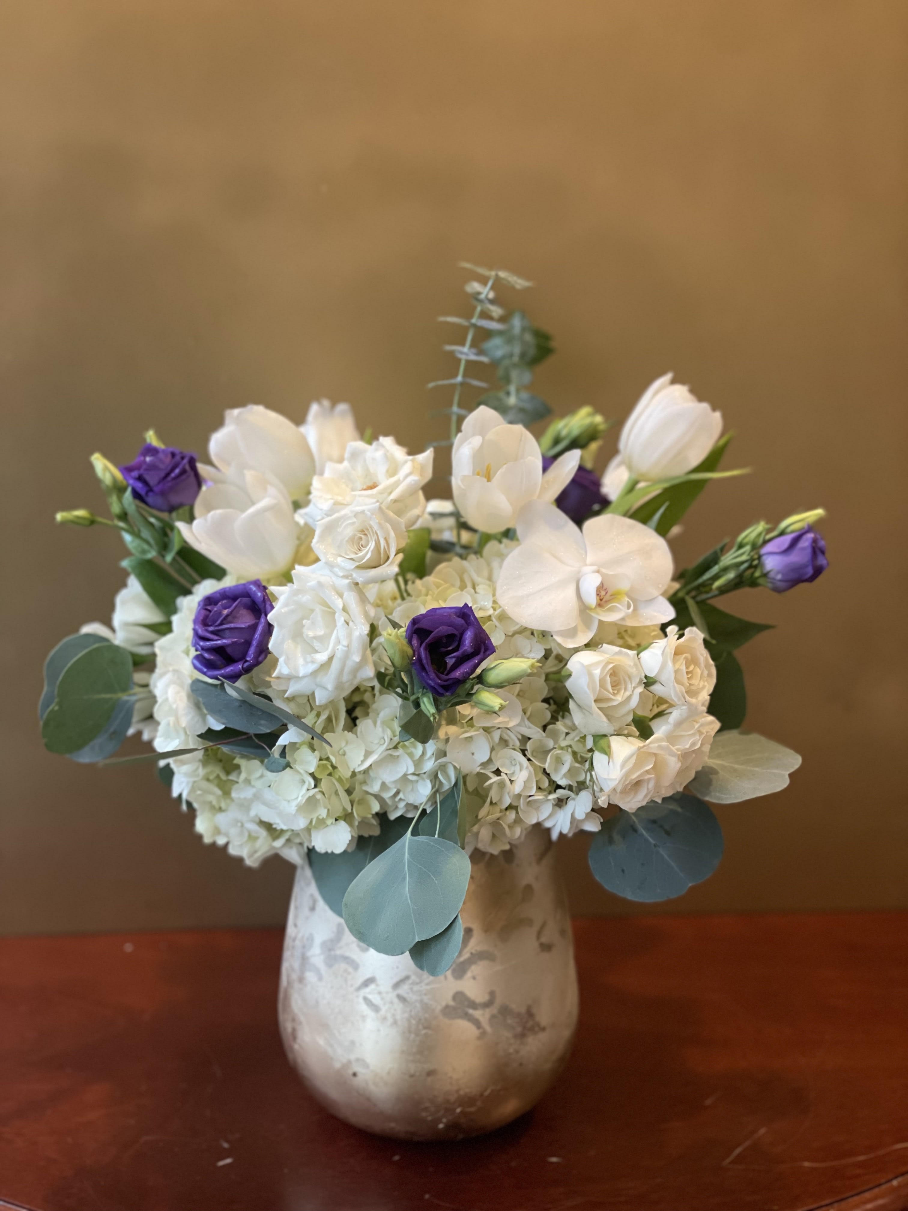 So Pretty So Pretty - Soft white spray roses, tulips white hydrangea and purple lisianthus beautifully arranged int this golden vase. *Note, vase is subject to substitution depending on supply and season.
