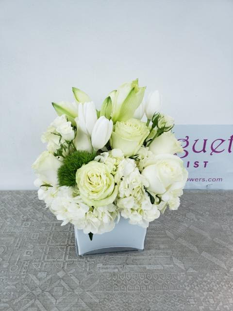 Timeless Elegance: The Classic Sweet White Arrangement - Step into a world of timeless beauty and serenity with the &quot;Classic Sweet White Arrangement.&quot; This enchanting ensemble captures the essence of pure elegance through a harmonious arrangement of sweet white blooms. Like a scene from a fairytale, this arrangement exudes a sense of sophistication and tranquility, evoking a feeling of calm and wonder. &quot;Varieties and colors of flowers may vary according to season and availability.&quot;  This arrangement includes a newly cleaned vase and good quality water &amp; flower food.  Item: 149  Care Instructions: For the best vase life, change the water every two days.