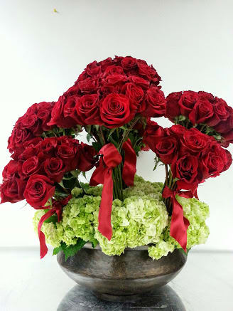 Eternal Love: A Timeless Arrangement of 100 Red Roses and Green Hydrangeas - Step into a world where love knows no limits with the &quot;Eternal Love Red Rose Arrangement.&quot; This spectacular bouquet of 100 red roses, accompanied by the lush beauty of green hydrangeas, is a masterpiece that speaks of enduring passion, timeless devotion, and a love that transcends boundaries. Through the language of flowers, this arrangement conveys a message of eternal love that will remain unwavering through the sands of time.  Varieties and colors of flowers may vary according to season and availability. This arrangement includes a newly cleaned vase and good quality water &amp; flower food.  Item: 170