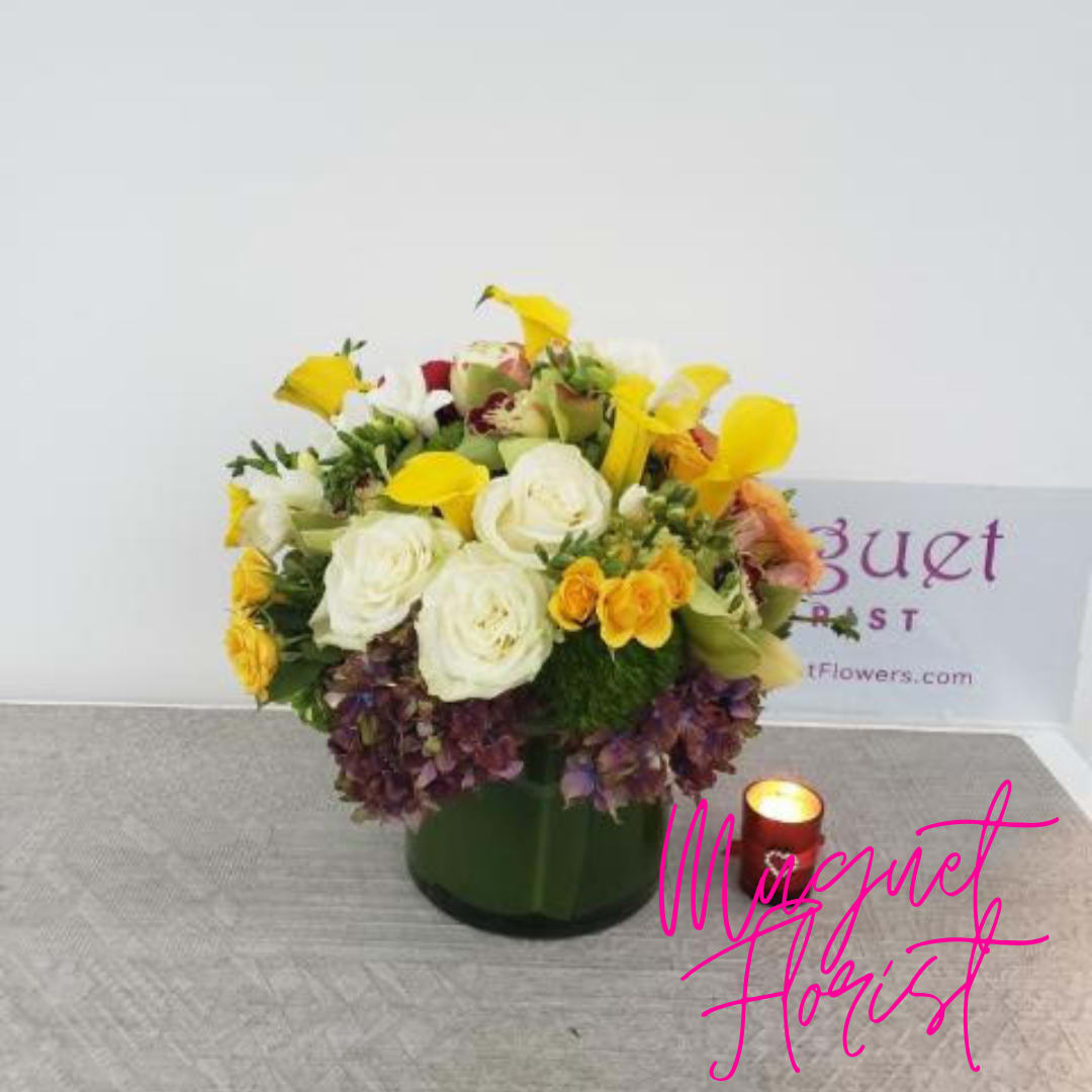 Sun-Kissed Harmony: A Yellow and White Bouquet - The combination of yellow and white in a bouquet creates a delightful harmony that captures the essence of sunshine and purity. The &quot;Sun-Kissed Harmony&quot; bouquet is a radiant and uplifting arrangement that blends the cheerful energy of yellow blooms with the pristine elegance of white flowers. This bouquet symbolizes the balance between vibrant joy and serene beauty, making it an excellent choice for various occasions. Join us as we explore the petals of this arrangement, where each flower represents the perfect blend of sunshine and purity.   Varieties and colors of flowers may vary according to season and availability. This arrangement includes a newly cleaned vase and good quality water &amp; flower food.  Item: 153  Care Instructions: Change the water every two days for the best vase life.