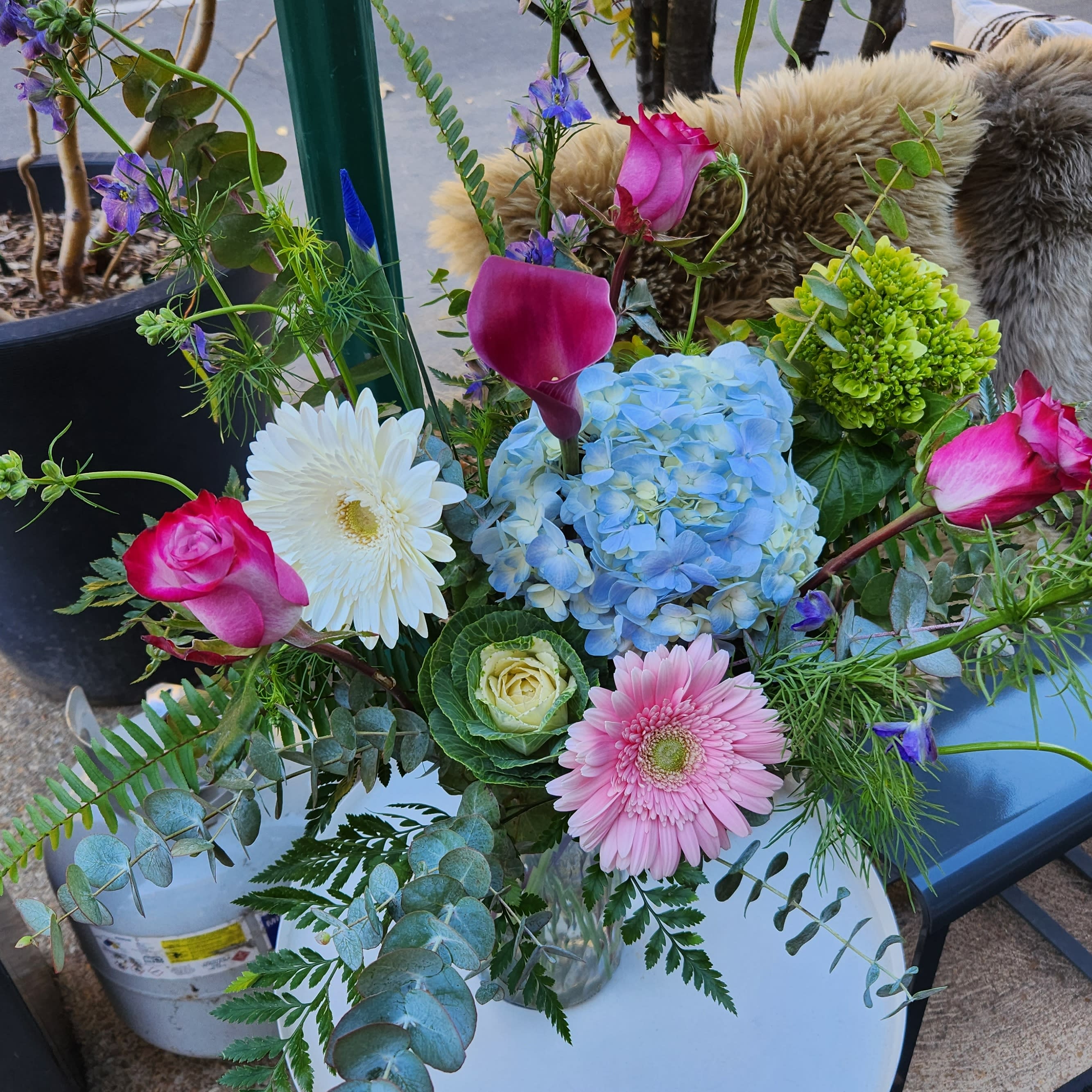 Designers Choice Traditional - A custom design of seasonal delicate flowers in a cylinder vase.  