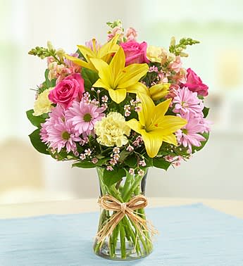 Fields of Europe Fields of Europe - With gorgeous fresh roses lilies carnations snapdragons and more this "field-gathered" bouquet designed in a glass vase and tied with raffia is a romantic taste of an Old World tradition that's sure to make Mom smile. As Shown : FOE