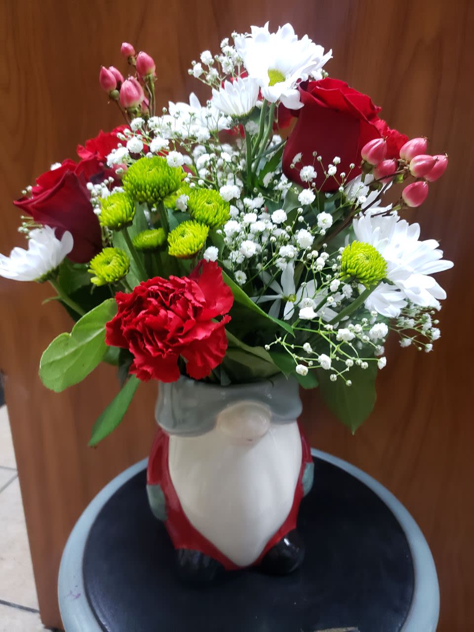 Gnome  Bouquet - 4 white daisies, 2 red roses,3 greens button, 3 stem of red berries . white baby breath ,4 red carnation and a gnome  vase