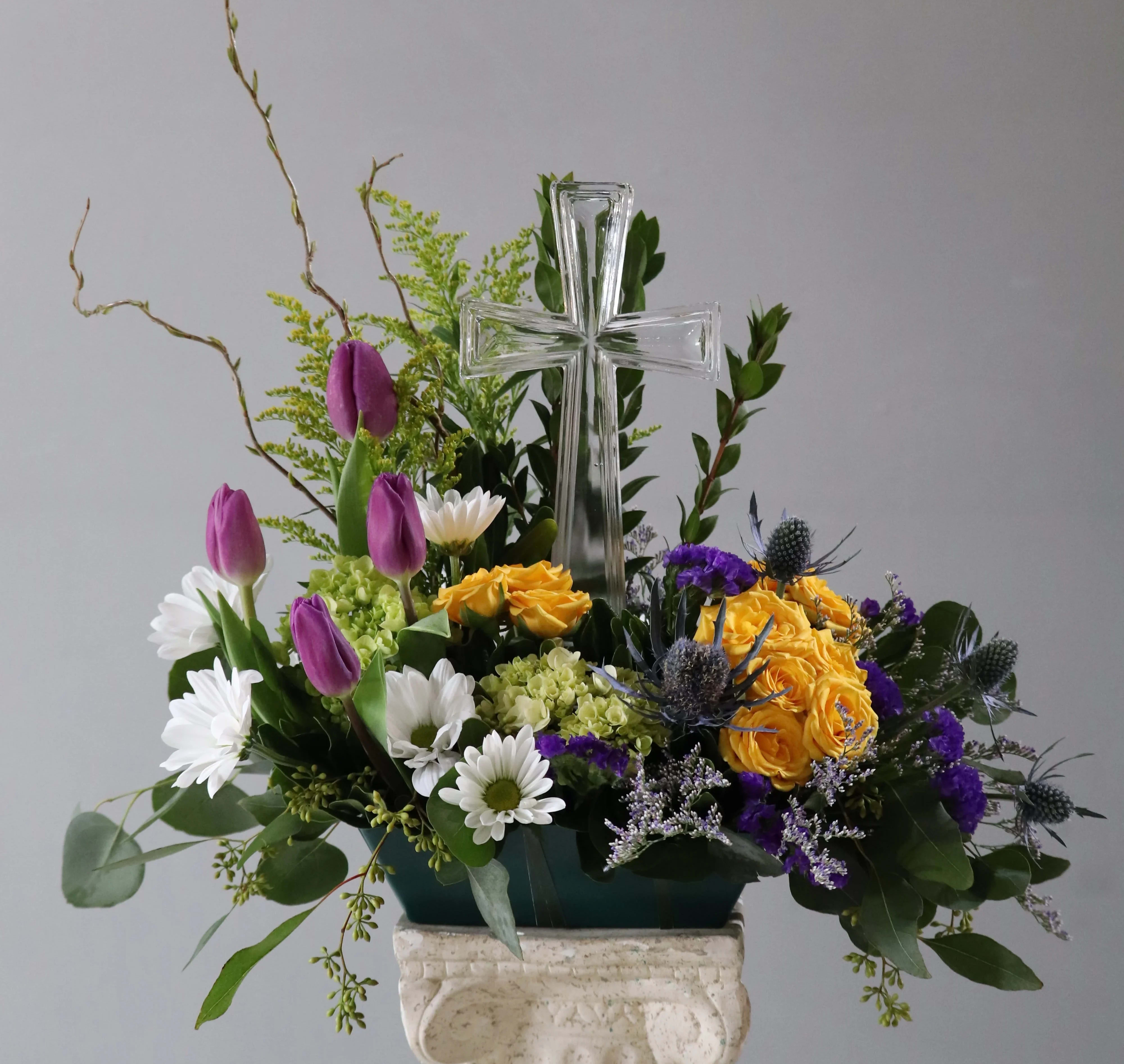 Grace - This arrangement with the cross and bright flowers is a reminder this Easter of the Grace and hope it brings.