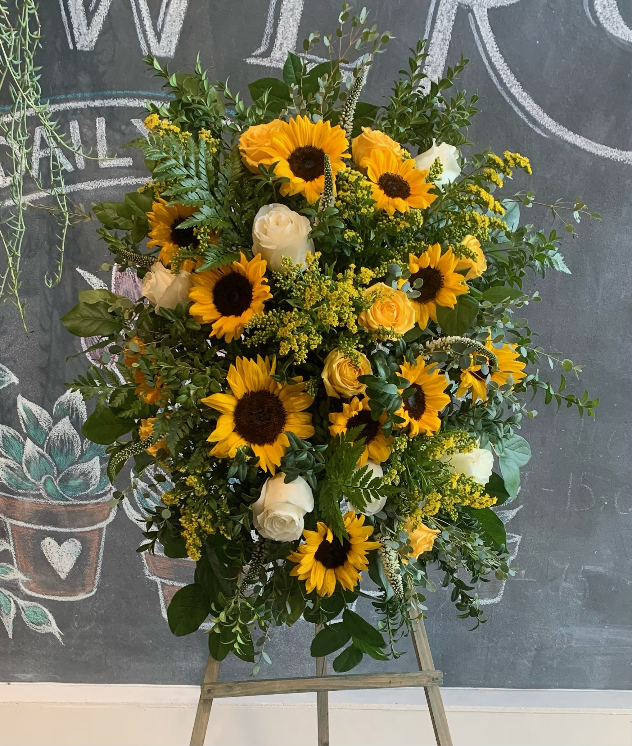 Sunflower Spray - A unique spray with various yellows bringing a smile to anyones face in times of sorrow. Plenty of blooms and blossoms fill this spray with love.