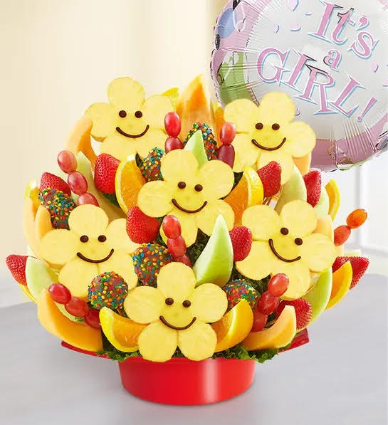 Happy Face Smile - This arrangement includes daisy-shaped pineapples with milk chocolate smiley faces; strawberries dipped in milk chocolate &amp; rolled in confetti sprinkles; plain strawberries; honeydew, cantaloupe &amp; orange wedges and grape skewers.  (Balloon can be added with a $5 additional charge.) Balloons available -Get Well -Happy Birthday -I Love You -Baby Girl/Boy -You are so special