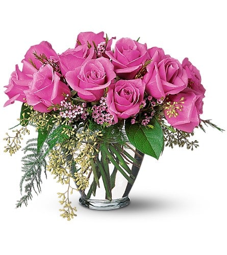 A Lavender Dozen - When you really want to wow them send these distinctive lovely roses. Twelve lavender roses with waxflower eucalyptus and plumosus in a classic glass vase.Approximately 12&quot; W x 10-1/2&quot; H Orientation: All-Around As Shown : TF32-4