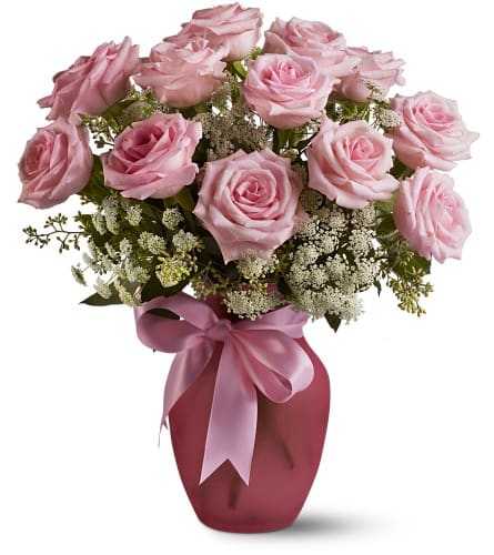 A Dozen Pink Roses and Lace - A vision of sheer loveliness this exquisite arrangement of pink roses and Queen Anne's lace in a rose-colored vase is a gift that will be long remembered. No special occasion? Even better. Arrangement includes 12 pink roses and Queen Anne’s Lace accented with seeded eucalyptus. Delivered in a frosted pink vase tied with a pink satin ribbon. Bouquet is approximately 12” W X 15” H. Orientation: All-Around As Shown : TFWEB332