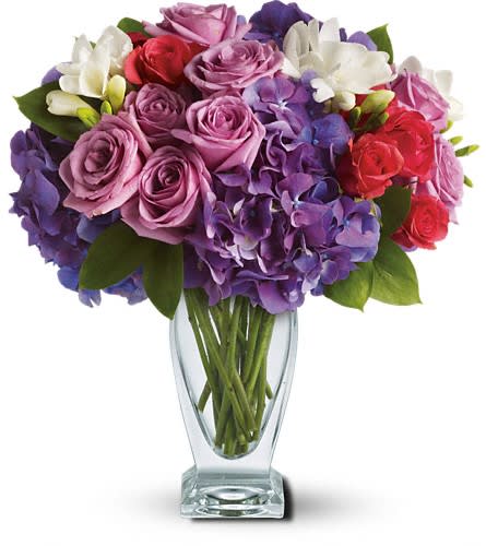 Teleflora's Rhapsody in Purple - A rhapsody of beauty is on stunning display in this arrangement. Gorgeous blossoms are beautifully arranged and delivered in a divine Couture Vase. Purple hydrangea lavender roses hot pink spray roses and white freesia arrive in style!Approximately 12 1/2&quot; W x 13 1/2&quot; H Orientation: All-Around As Shown : T51-1ADeluxe : T51-1BPremium : T51-1C