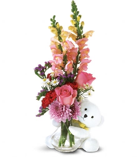 Teleflora's Bear Hug Bear with Pink Roses Teleflora's Bear Hug Bear with Pink Roses - Send Teleflora's adorable little bear with enchanting flowers and someone special will think you're just as sweet as can be. Roses carnations chrysanthemums and asters arrive in a glass vase with a Teleflora keepsake bear. Approximately 7" W x 16 1/2" H Orientation: One-Sided As Shown : TF19-2