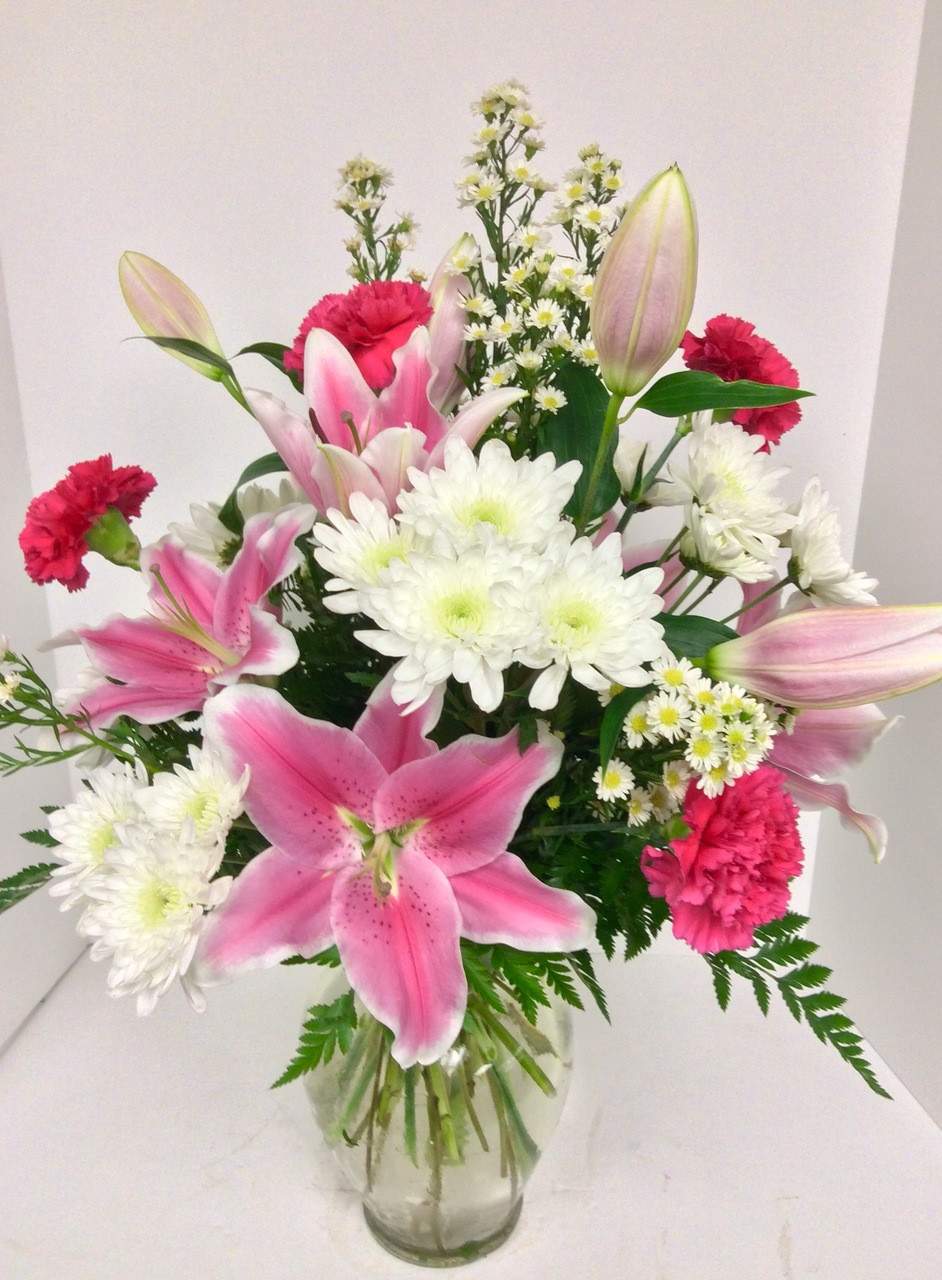 Better Together - This beautiful vase contains a stunning display of pink Oriental Lilies and Carnations, perfect to celebrate any occasion. The pink Oriental Lilies add a delicate and exotic touch to the bright and cheerful Carnations, making it ideal to brighten up any home or office. This vase will make a wonderful gift to show your love and appreciation.