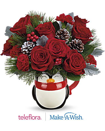 Teleflora's Send A Hug® North Pole Penguin - Bursting with Christmas blooms, this perky penguin is delighted to deliver your best wishes for a happy holiday season! The glazed ceramic mug is food-safe for sipping fun