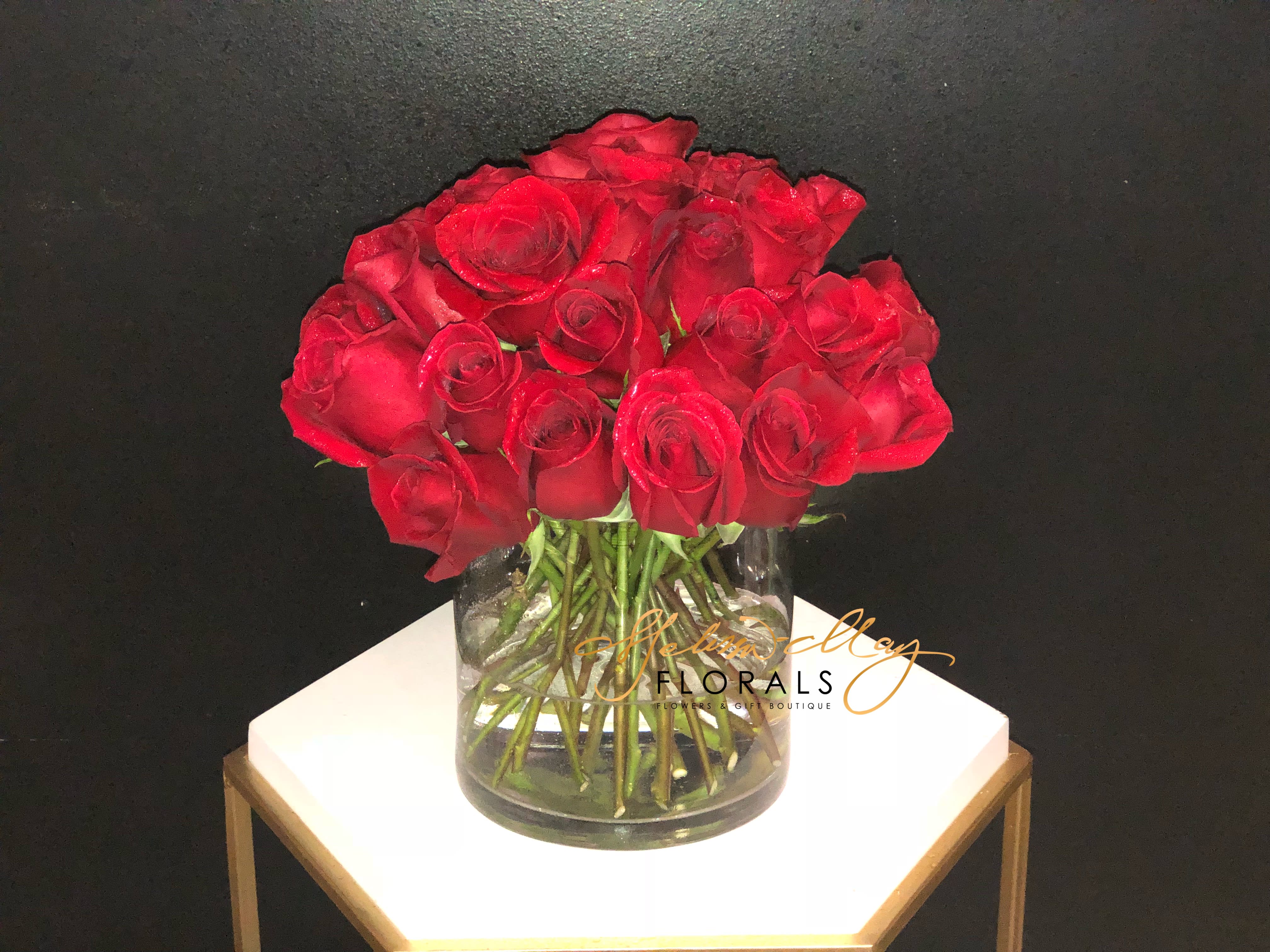 Three Dozen Red Roses  - Make a bold statement with this beautifully simple design. Three Dozen Red Roses is the perfect gift for Valentine's Day, an Anniversary, or when anytime you're feeling romantic.   Arrangement Details: Three dozen red roses in a glass cylinder vase.  APPROXIMATE DIMENSIONS are 12&quot;D X 12&quot;H 