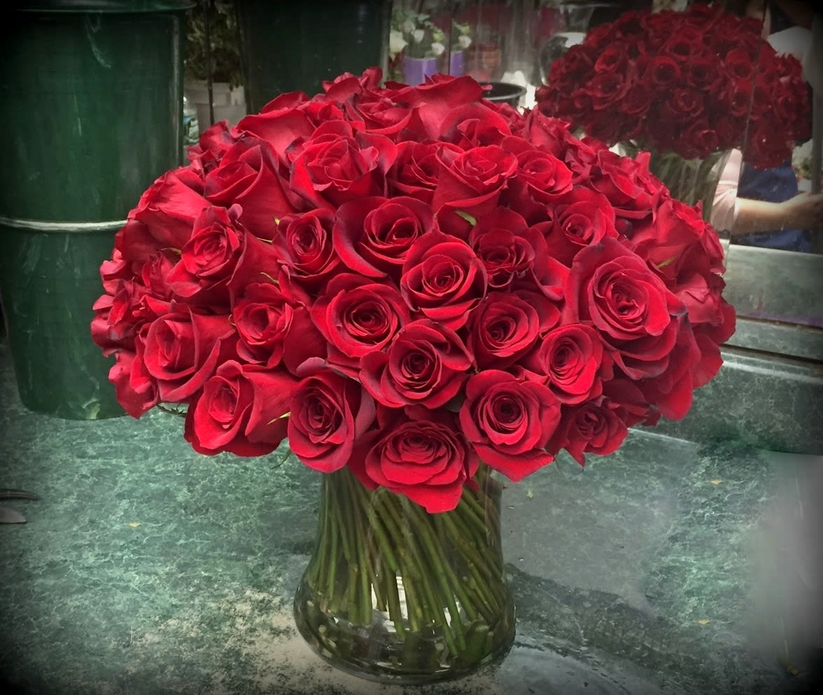 Whole Lotta Love - ADDITIONAL NOTICE IS REQUIRED FOR THI SELECTION. 100 red roses hand-tied and placed in a glass vase...a luxurious display that's hard to beat!