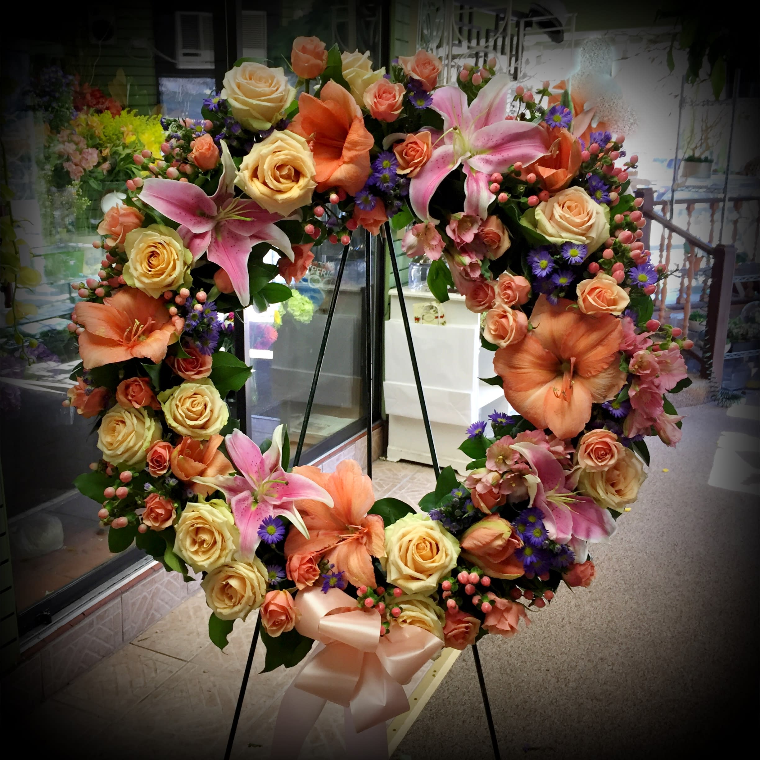 Graceful Wreath - Family and friends will recollect how special their loved one was with this gentle and timeless circle of fragrant blooms to celebrate sweet memories. 