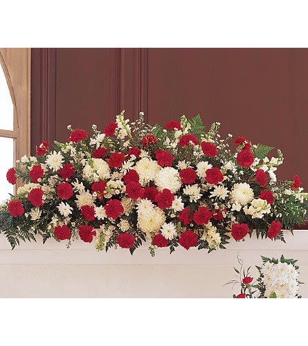 Hope and Honor Casket Spray - With its striking red and white flowers this casket spray reflects both your respect and your sympathy. One full-couch spray arrives with red and white carnations and white chrysanthemums asters and snapdragons.Approximately 59&quot; W x 27&quot; H Orientation: One-Sided As Shown : TF206-3