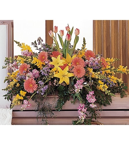 Blooming Glory Casket Spray - This colorful half-couch spray blooms with bright flowers promising that there's always hope and glory. One half-couch casket spray is decorated with yellow lilies and snapdragons pink gerberas lavender stock pink tulips and lavender waxflower. Approximately 44&quot; W x 37&quot; H Orientation: All-Around As Shown : TF199-7
