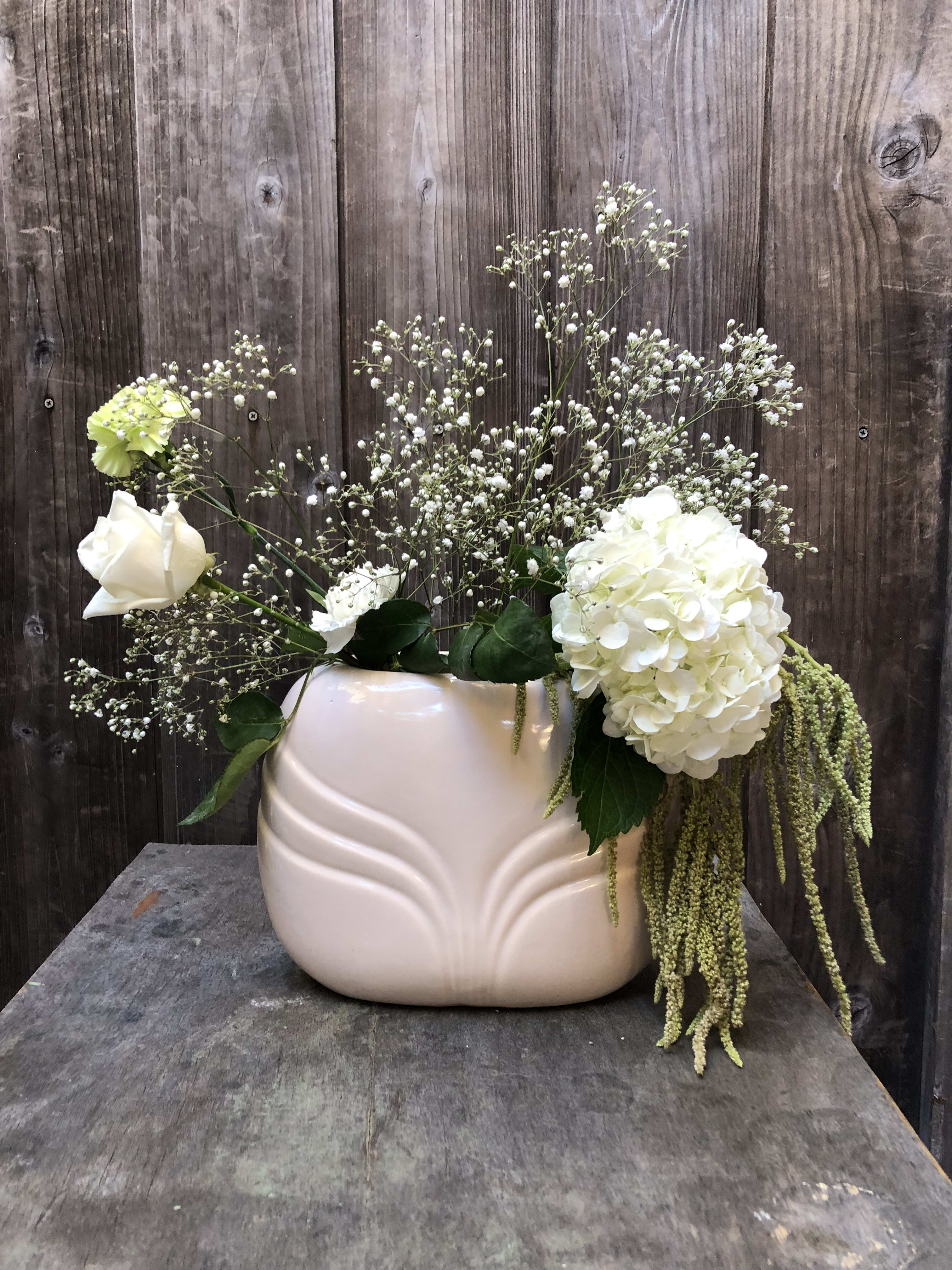 Optical Illusion Hair Arrangement Optical Illusion Hair Arrangement - Is it a vase of flowers or is it a person with hair? This fun arrangement is made with carnations, hygrangea, amaranthus, and baby's breath. Exact vase may not be available. Will try to provide a vase that will resemble the one in picture as much as possible.
