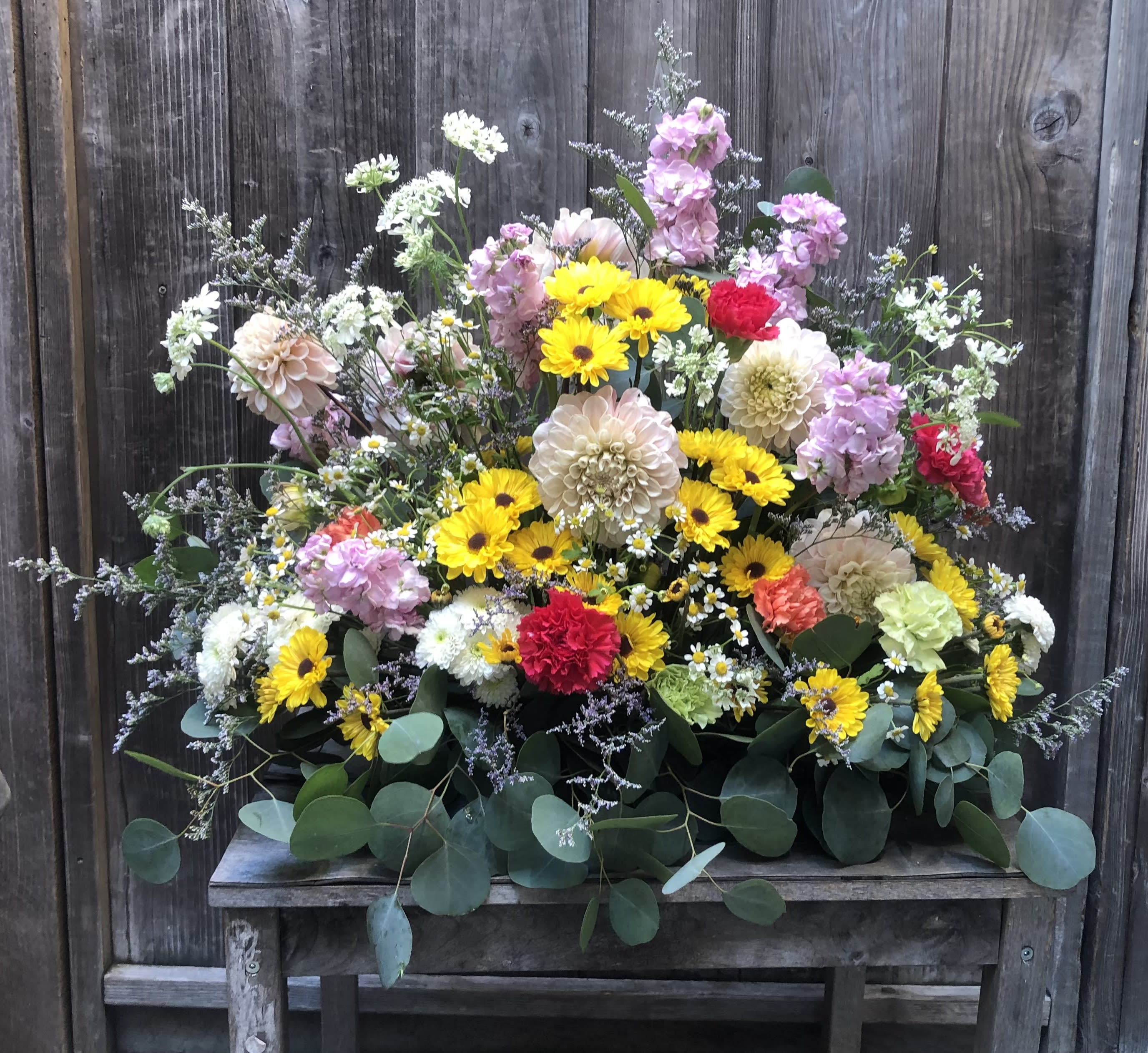 Sweet Summer Surprise Sweet Summer Surprise - A table arrangement made with chrysanthemum, dahlias, delphinium, casino daisies, carnations, stock, queen's anne's lace, and misty blue.