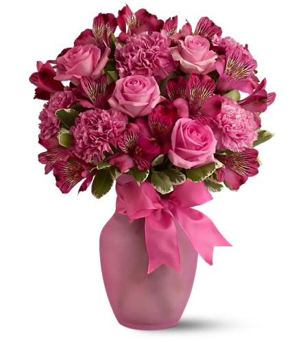 Pink Blush Bouquet - Pretty in hot pink this ravishing bouquet of flowers in a matching vase is the ultimate gift for a feminine friend. She'll love the colors the dainty ribbon and the charming vase which will be a favorite for years to come. Arrangement includes pink alstroemeria pink carnations pink roses accented with variegated pittosporum. Delivered in a hot pink glass vase decorated with a hot pink ribbon. Bouquet is approximately 12? W X 16? H Orientation: One-Sided As Shown : TFWEB330
