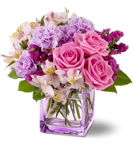 Teleflora's Beautiful Day - Give someone a beautiful day? send them this mix of fresh flowers in delectable shades of raspberry lavender and pink nestled in a lavender glass vase. The bouquet is a study in loveliness? and the vase can be reused for flowers or as a pretty desk accessory. Pink roses and alstroemeria raspberry sinuata statice and lavender carnations are delivered in a lavender glass Teleflora cube vase. Approximately 10&quot; (W) x 10&quot; (H) Orientation: All-Around As Shown : TFWEB138