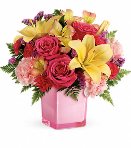 Teleflora's Pop Of Fun Bouquet - Turn up the fun! Make any day extra special with a surprise delivery of joyful blooms in a stylish cube vase. This bouquet of pink roses and luxurious peach lilies will make their mood soar! This fresh fun mix of pink roses peach asiatic lilies peach alstroemeria pink carnations and pink miniature carnations is accented with raspberry sinuata statice and leatherleaf fern. Delivered in a glass cube.Approximately 14&quot; W x 12 3/4&quot; H Orientation: One-Sided As Shown : TEV45-3ADeluxe : TEV45-3BPremium : TEV45-3C