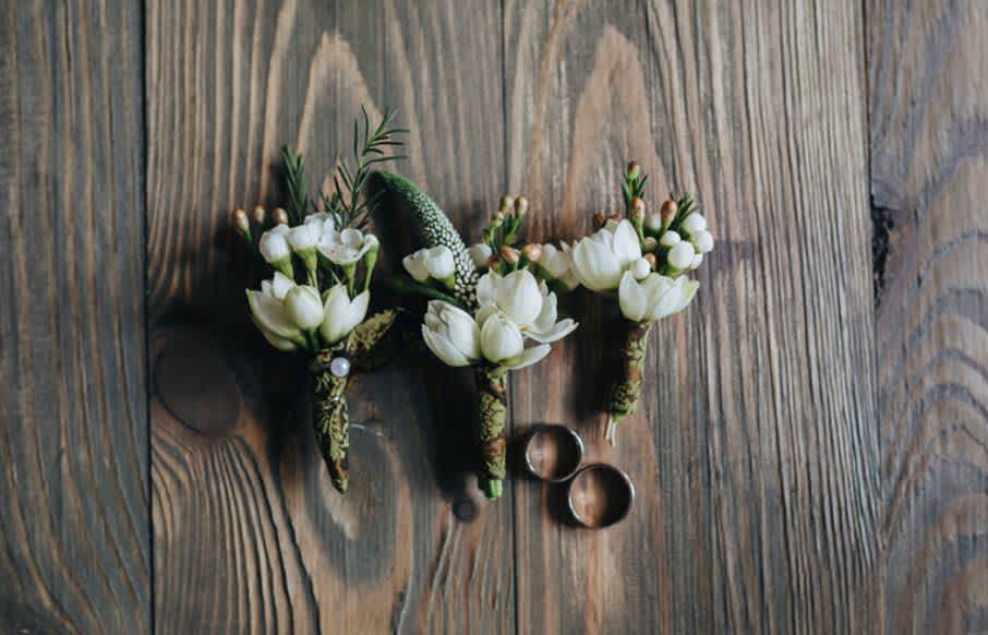 White freesia boutonierre White freesia boutonierre - Single white freesia, waxflower, and pine boutonierre.