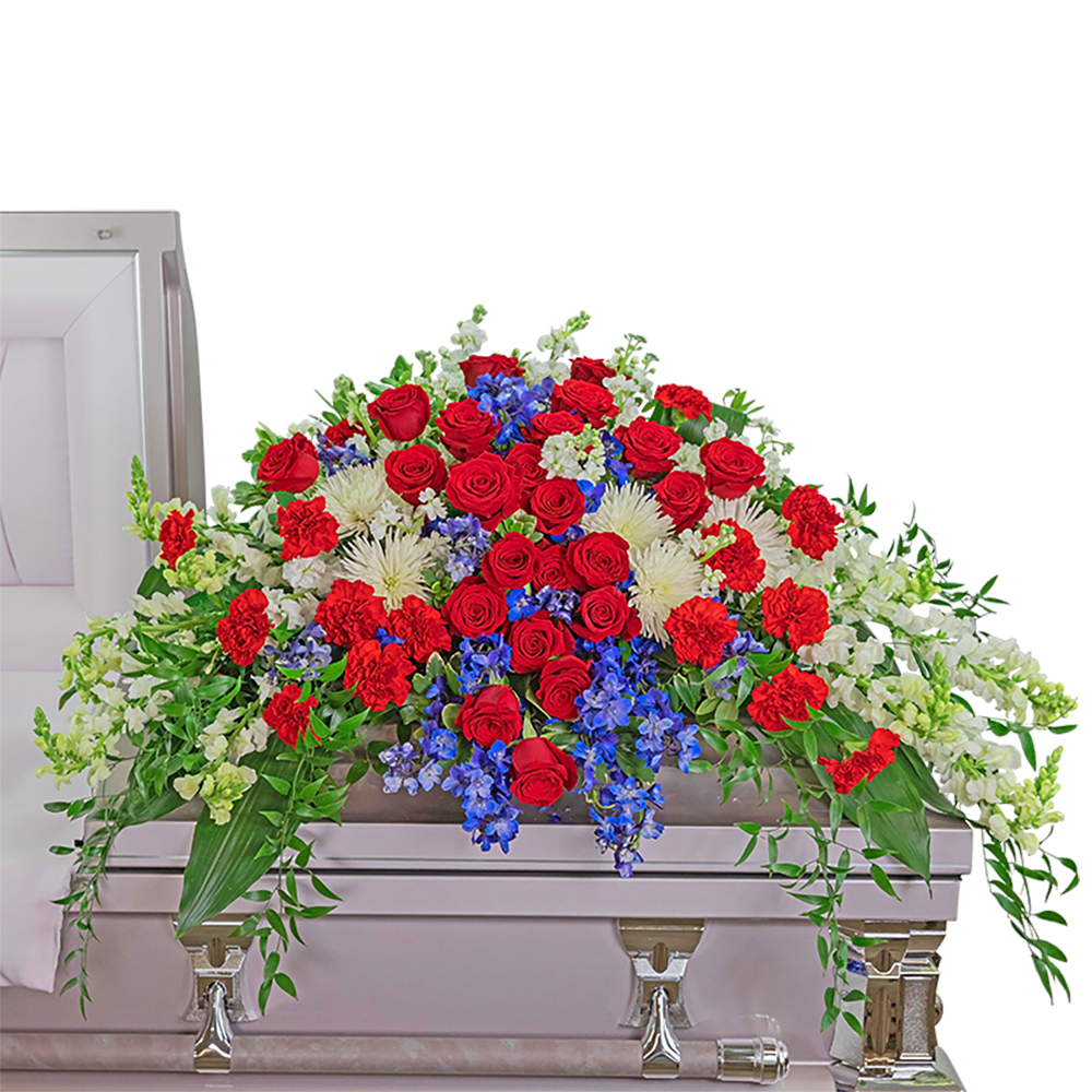 Valiant Honor Casket Spray - This beautiful red, white, and blue casket spray honors the valiant effort of the ones who served our country  It is filled with red roses and carnations, blue delphinium, and white snapdragons surrounded by a variety of premium foliage. The Casket Spray is typically provided by the spouse or the immediate family as a heartfelt memorial and is designed to drape over the lid of the casket for a funeral or memorial.