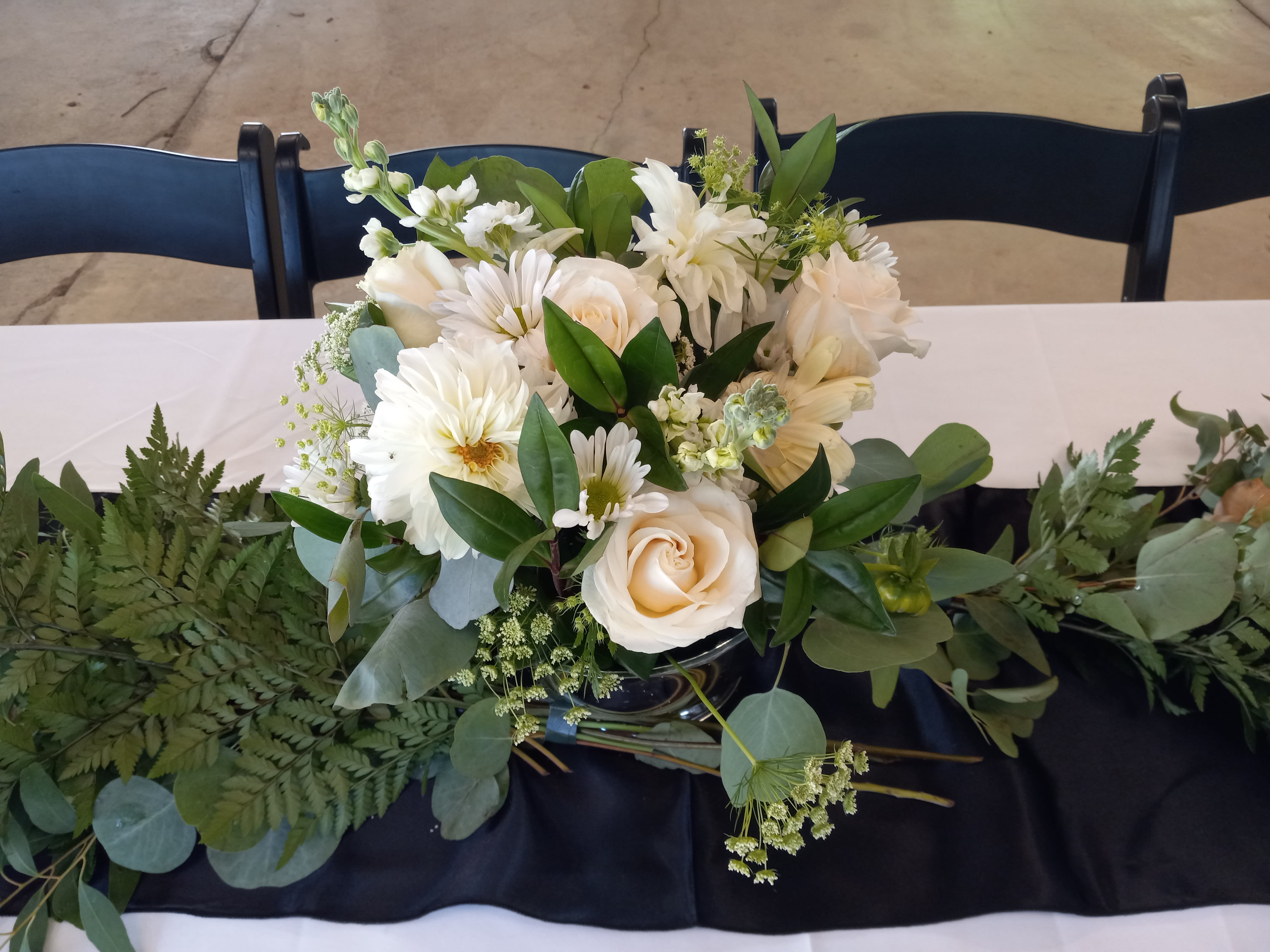 Alexis wedding reseption centerpiece  - Beautiful white roses, hydrangea, alstroemeria, carnations and greens in a silver plastic compote vase 