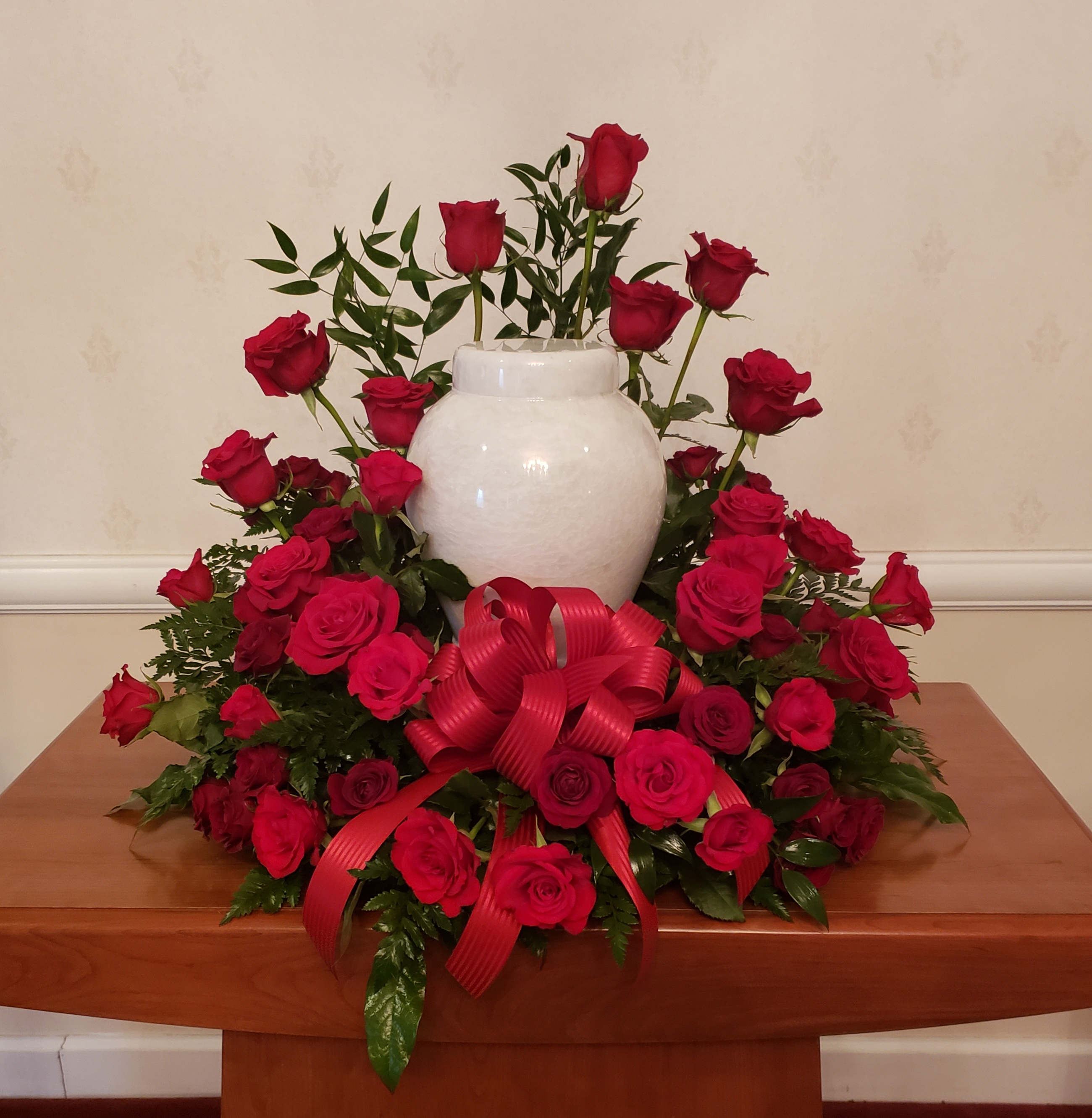 TPP-SR04 - Red Roses and spray roses adorn this beautiful arrangement for the urn. 
