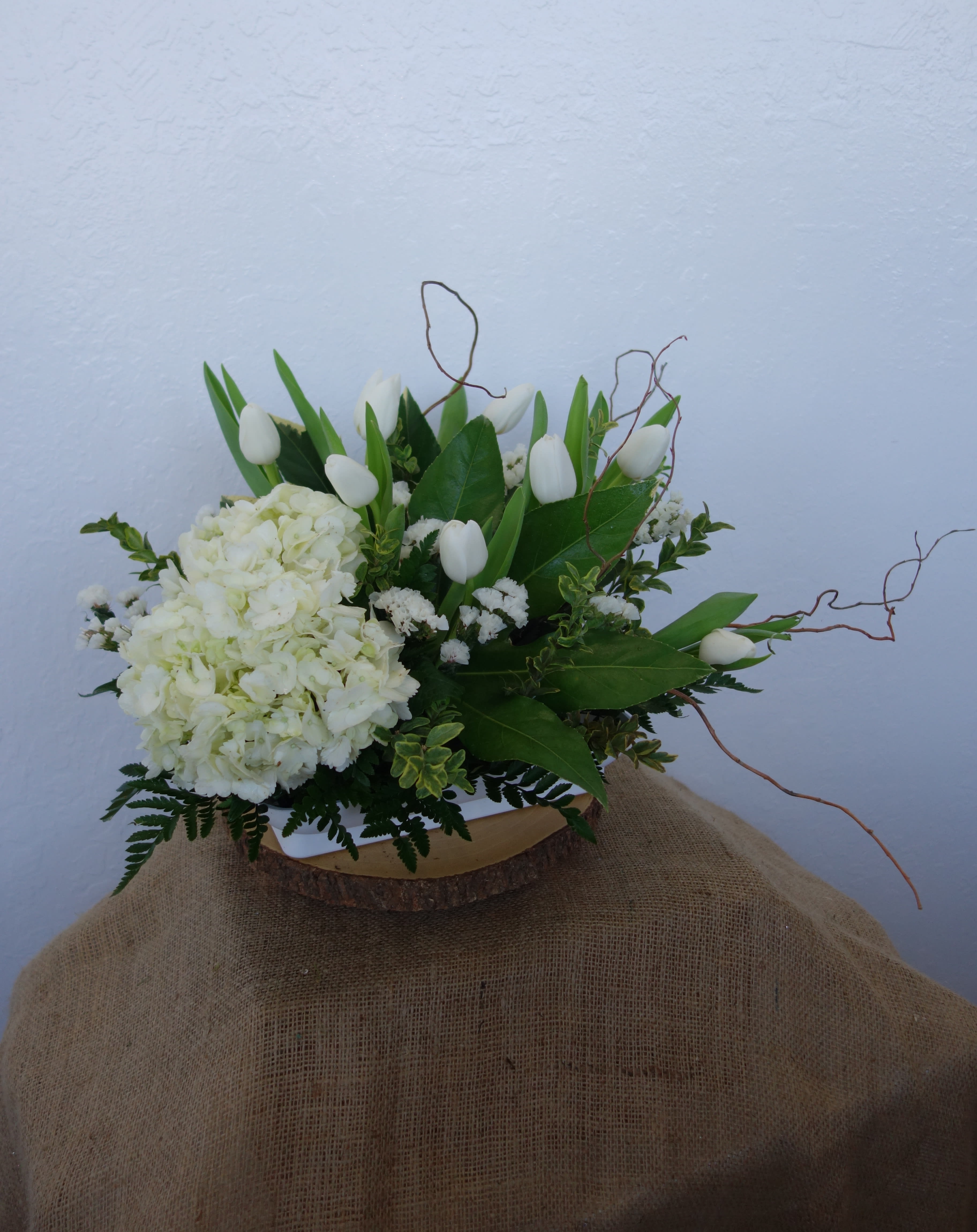 Elegant White Bouquet - Simple and elegant white Hydrangea and Tulips with curly willow and mix greens.  Standard: Show as Picture