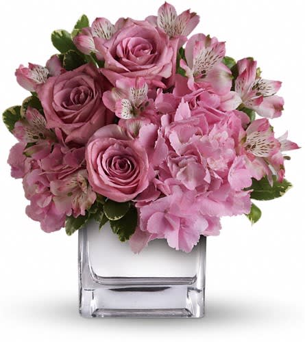 Teleflora's Be Sweet Bouquet - Nothing's too sweet for the sweetest woman in the world. Surprise her with a delightfully dainty bouquet featuring delicate lavender roses and pink hydrangea in a sparkling silver cube vase. You'll make her day her week her month! The beautiful bouquet includes pink hydrangea lavender roses and pink alstroemeria accented with fresh greenery.Delivered in a contemporary glass cube with a mirrored silver finish.Approximately 11&quot; W x 11 3/4&quot; H Orientation: One-Sided As Shown : T404-1ADeluxe : T404-1BPremium : T404-1C