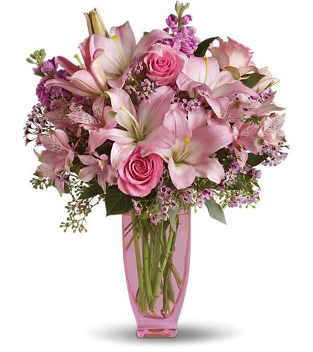 Teleflora's Pink Pink Bouquet with Pink Roses - Think pink. Think pretty. Think present. This beautifully feminine bouquet makes a wonderful gift for any woman. Light pink asiatic lilies and alstroemeria share the spotlight with pink roses and waxflower. Lovely lavender stock and seeded eucalyptus have been added to complete this bouquet that's delivered in a pink Jewel Vase. A perfectly pink present!Approximately 15 1/2&quot; W x 19 3/4&quot; H Orientation: All-Around As Shown : T18-2ADeluxe : T18-2BPremium : T18-2C