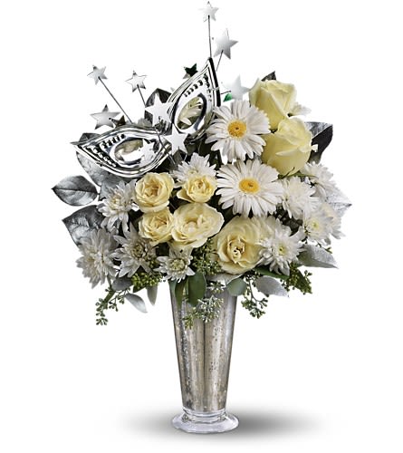 Teleflora's Toast of the Town - What a delightful way to bring in the New Year! This fun and fabulous arrangement will light up the celebration long past midnight. It's glittery glamorous and altogether a great choice. So delightfully different this bouquet shines with its stunning Mercury Glass Vase silvery masquerade mask a spray of silver stars and dazzling white roses spray roses miniature gerberas and more.Approximately 13&quot; W x 18&quot; H Orientation: One-Sided As Shown : T132-3ADeluxe : T132-3BPremium : T132-3C