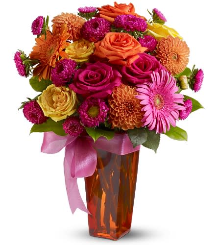 Strikingly Chic - An eye-catching display of blossoms in sizzling hues of hot pink fiery orange and sunshine yellow is arranged in a tall glass vase that's decorated with a pink bow. A chic and stylish floral arrangement that's guaranteed to impress for a birthday or any special day. A mix of fresh flowers such as roses dahlias and gerberas – in shades of hot pink orange and yellow – is delivered in a glass vase that’s decorated with a pink ribbon. Approximately 11.5&quot; (W) x 17&quot; (H) Orientation: All-Around As Shown : TFWEB305