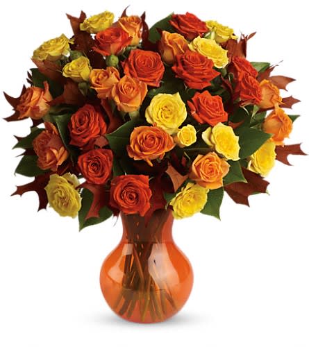 Teleflora's Fabulous Fall Roses Teleflora's Fabulous Fall Roses - Autumn is a many-splendored thing and this glorious bouquet is proof. The season's most amazing flowers in a chic serendipity vase - what a spectacular splash of color and style! Bask in it. Yellow orange and light-orange spray roses - accented with preserved oak leaves and lemon leaf - are delivered in a sparkling orange Serendipity vase.Approximately 14" W x 15" H Orientation: One-Sided As Shown : TFL02-3ADeluxe : TFL02-3BPremium : TFL02-3C
