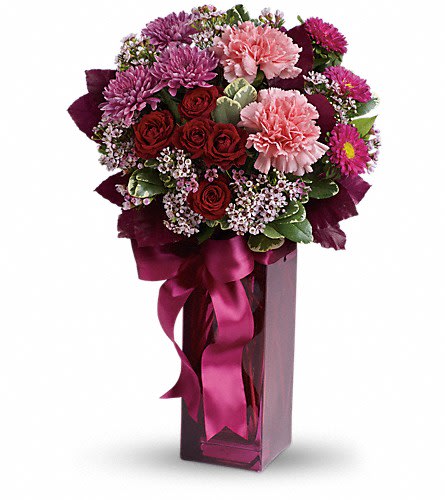 Teleflora's Fall in Love - Summer may be the season for weddings but romance blossoms in the fall. Cooler weather and brilliant colors lend themselves perfectly to falling in love. Dazzling dark red roses pink carnations purple cushion spray chrysanthemums hot pink matsumoto asters and more are delightfully arranged in a dramatic burgundy vase that comes complete with a satin ribbon.Approximately 11&quot; W x 15 3/4&quot; H Orientation: All-Around As Shown : T173-2ADeluxe : T173-2BPremium : T173-2C