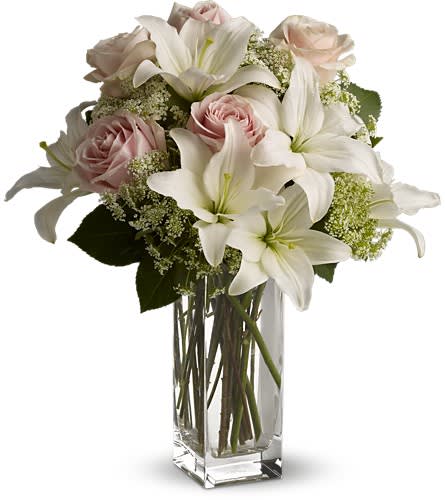 Teleflora's Heavenly and Harmony - Heavenly hues and pretty petals are in perfect harmony in this gorgeous arrangement. Lovely for a birthday anniversary or just because it's simply stunning! Light pink roses white asiatic lilies Queen Anne's lace and salal are beautifully arranged in a glass vase. Heaven sent? Well someone will think you're an angel for sending it!Approximately 10&quot; W x 18&quot; H Orientation: One-Sided As Shown : T55-1ADeluxe : T55-1BPremium : T55-1C