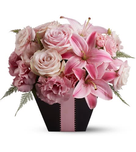 At First Blush - Searching for a floral arrangement that's fabulous and flirty? Look no further than this blushing bouquet created entirely from blossoms in pretty shades of pink and accented with a pink satin ribbon. A beautiful birthday gift or a stunning centerpiece for a pink-themed party. A mix of fresh flowers such as roses and Asiatic lilies all in shades of pink are delivered in a vase decorated with a pink satin ribbon. Approximately 11.5&quot; (W) x 11&quot; (H) Orientation: All-Around As Shown : TFWEB299