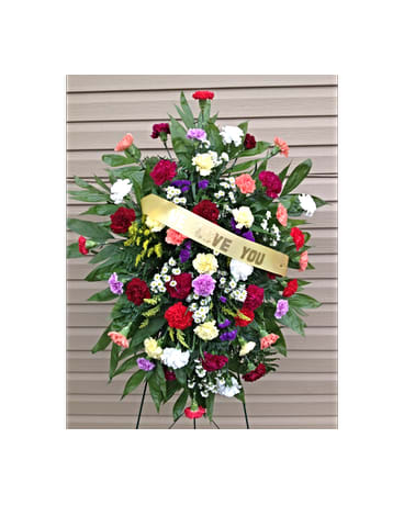 Rays Of Solace Spray - This hand arranged standing spray has multi colored Carnations and a ribbon that can be customized to say a few words of your choice. All colors are subject to change due to availability.    FCF-0307