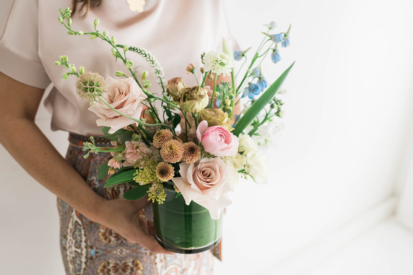 Pastel &amp; Earthy Designer's Choice - Lovely mix of pastel &amp; earthy premium seasonal blooms. This is a small arrangement 13&quot; tall approximately.
