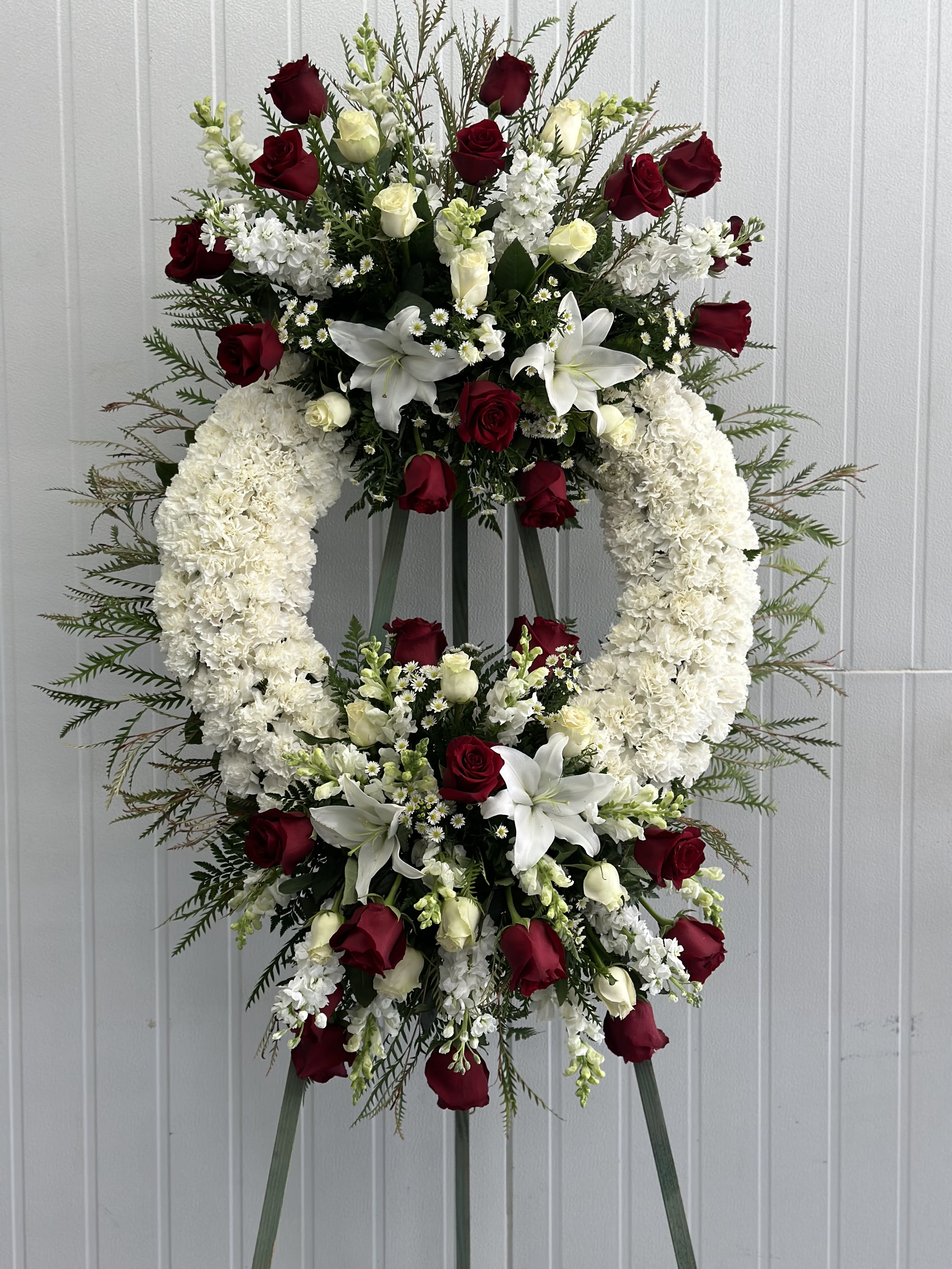 True  Sympathy - Show that your heart is with them. This lovely spray of white and red flowers in the shape of a wreath .