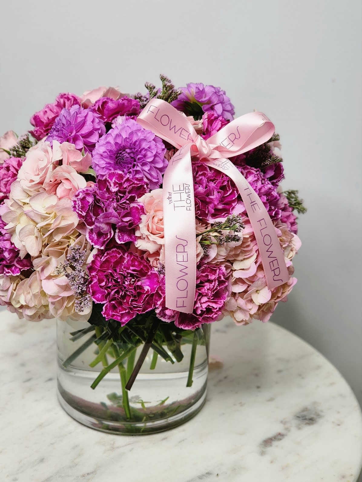 Lavander Dahlias - A vibrant bouquet blending the richness of purple dahlias with the delicate charm of pink roses.