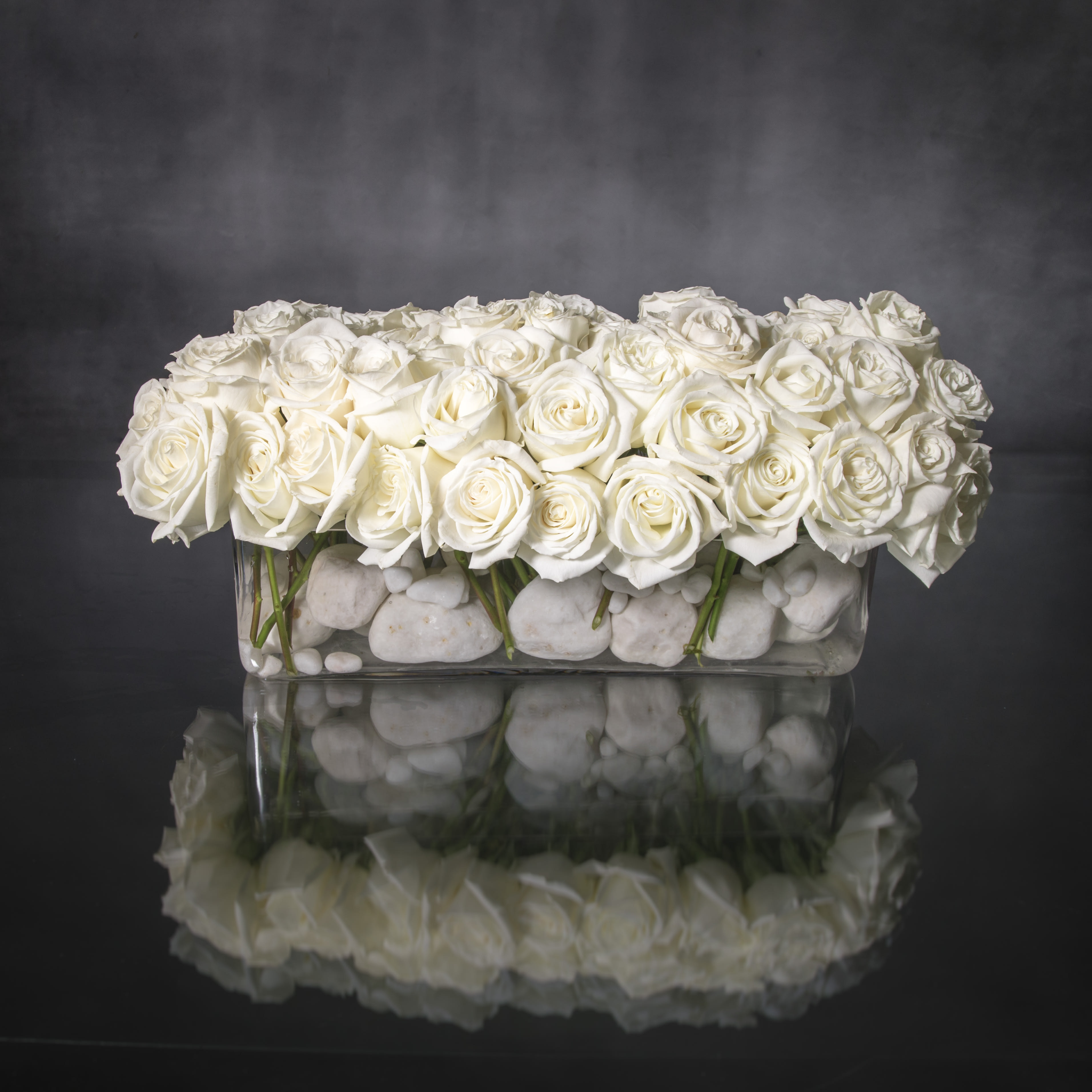 Crème de la Crème - 100 Roses  - This sophisticated design features 100 Creamy White Roses set in a rectangular glass vase. Your excellent taste is apparent for all occasions with this sophisticated, sleek floral gift.  