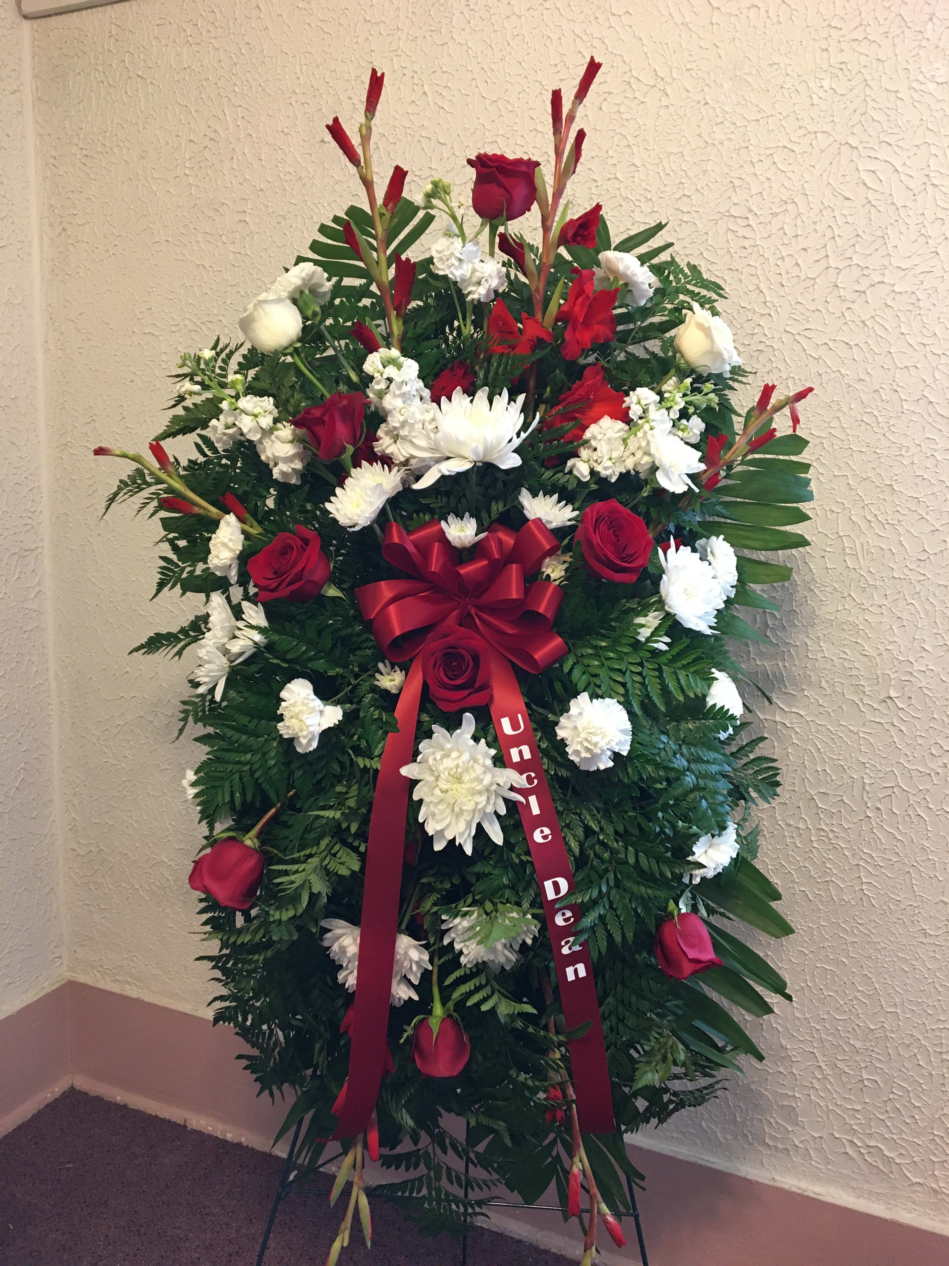 Red and White Standing Spray - Standing spray arrangement includes gladiolus, lilies, roses, carnations, mums, snapdragons, filler and assorted greens, personalized banner ribbon  on a standing easel