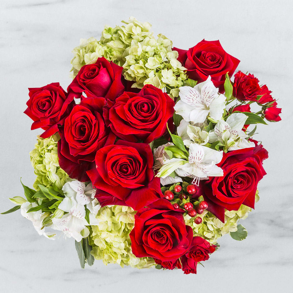 Winter Romance By BloomNation™ Winter Romance By BloomNation™ - It’s like winter was designed specifically for love. Snuggling on cold winter mornings, taking walks together through snowy meadows, celebrating the small joys of life over a warm winter beverage. There’s nothing better than a winter romance. Until now. Introducing the Winter Romance flower arrangement. If you want to make your winter romance even more romantic, here’s your chance.