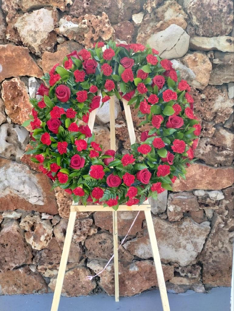ROUND LOVE CROWN ROUND LOVE CROWN - INCLUDES RED ROSES AND RED CARNATIONS WITH GREENERY CAN ALSO BE MADE IN ALL WHITE OR WHITE WITH YELLOW
